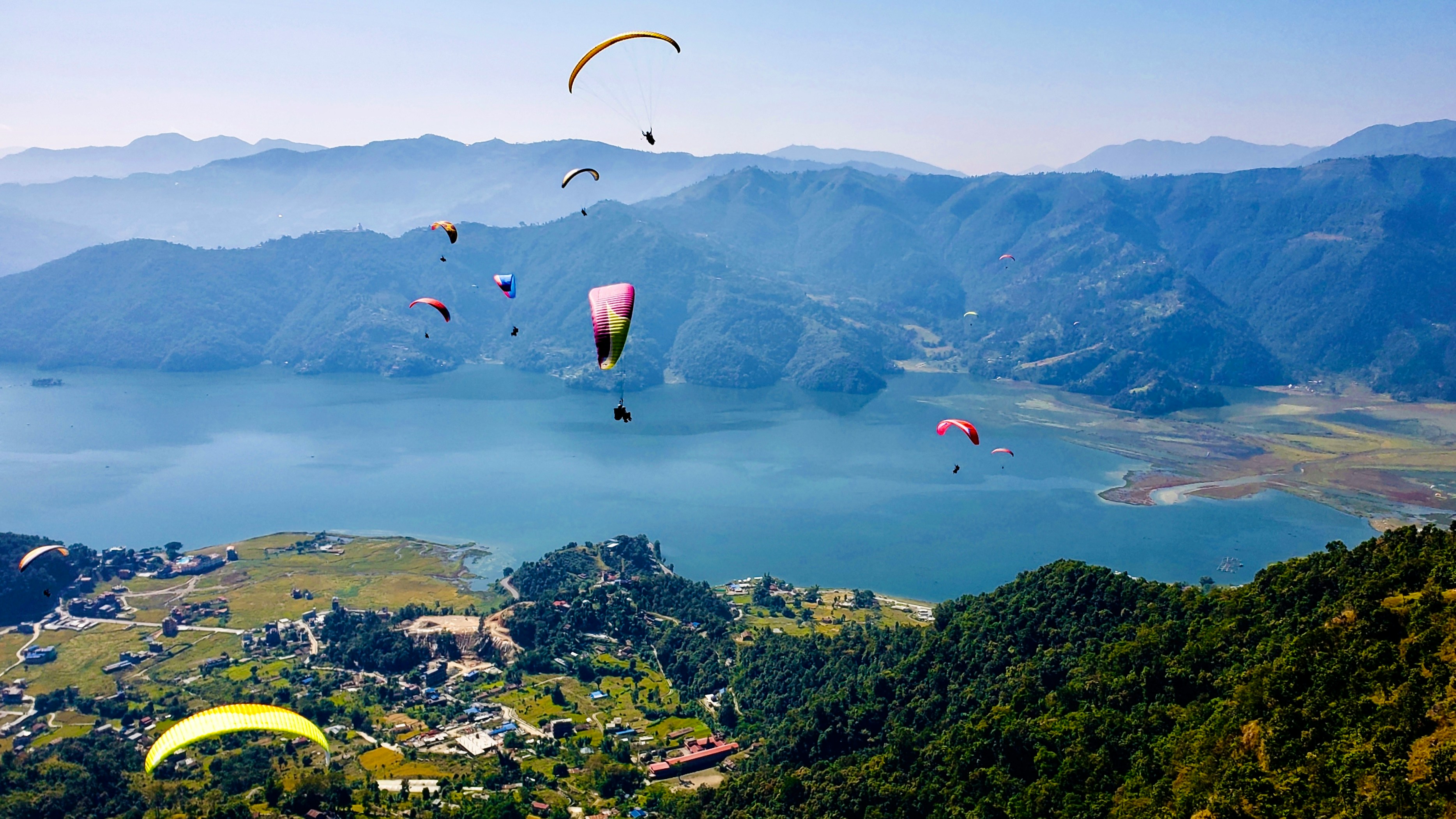 paragliders at phewa lake