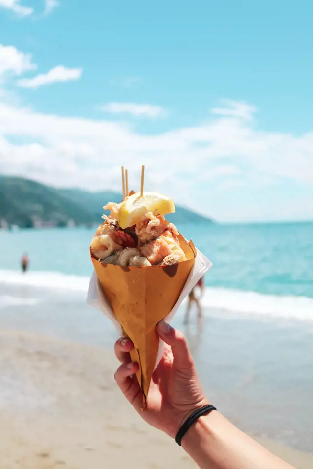 seafood in a cone at cinque terre unsplash